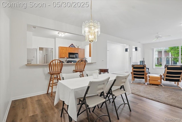 16490 Norfolk Dr, Macomb, MI 48044 - dining area featuring wood finished floors, a chandelier, ceiling fan, and baseboards