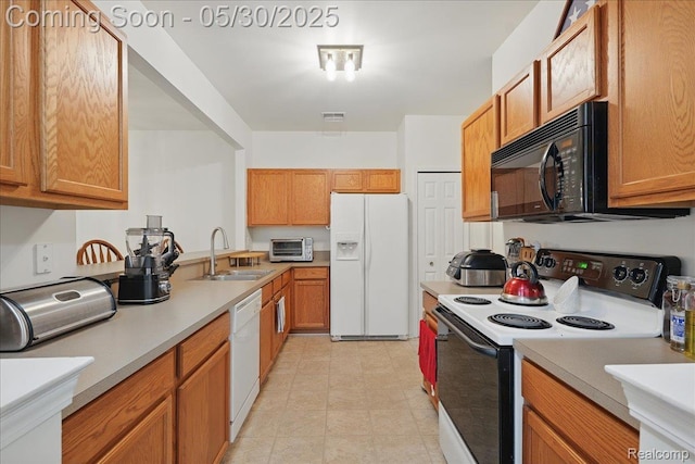 16490 Norfolk Dr, Macomb, MI 48044 - kitchen featuring white appliances, a sink, light countertops, and brown cabinets