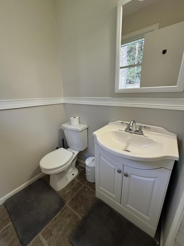 1335 N Sherman Rd, Ludington, MI 49431 - half bath featuring toilet, vanity, baseboards, and tile patterned floors