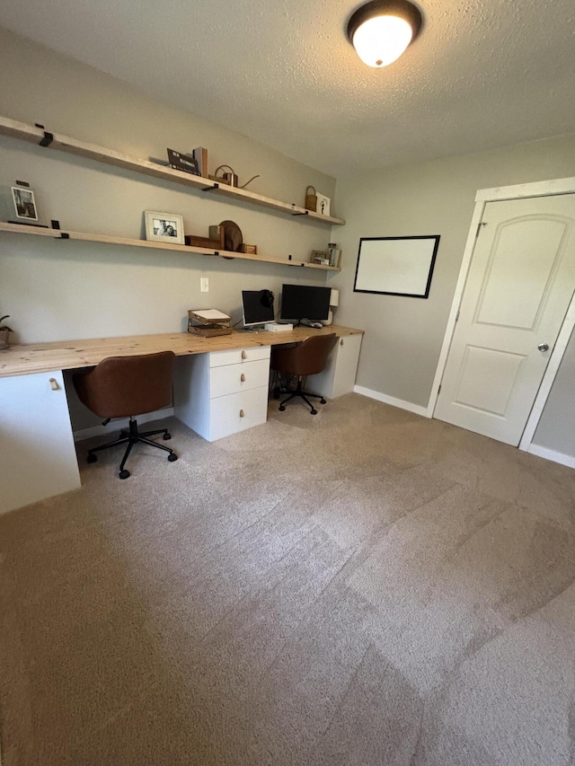 1335 N Sherman Rd, Ludington, MI 49431 - office space featuring built in study area, a textured ceiling, carpet flooring, and baseboards