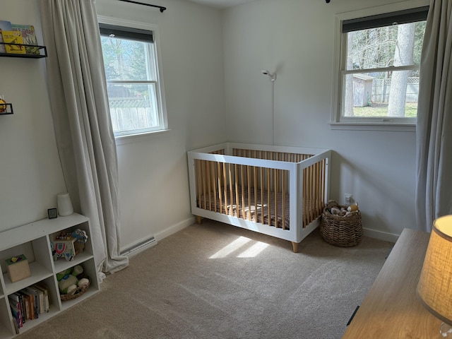 1335 N Sherman Rd, Ludington, MI 49431 - bedroom with carpet, a crib, and baseboards