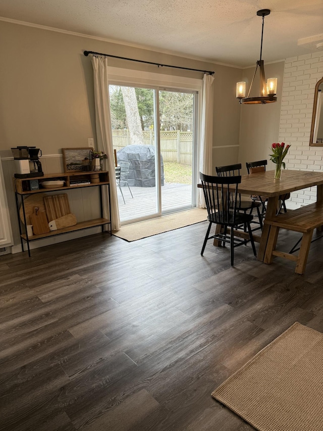 1335 N Sherman Rd, Ludington, MI 49431 - dining space with a chandelier, dark wood-type flooring, and crown molding