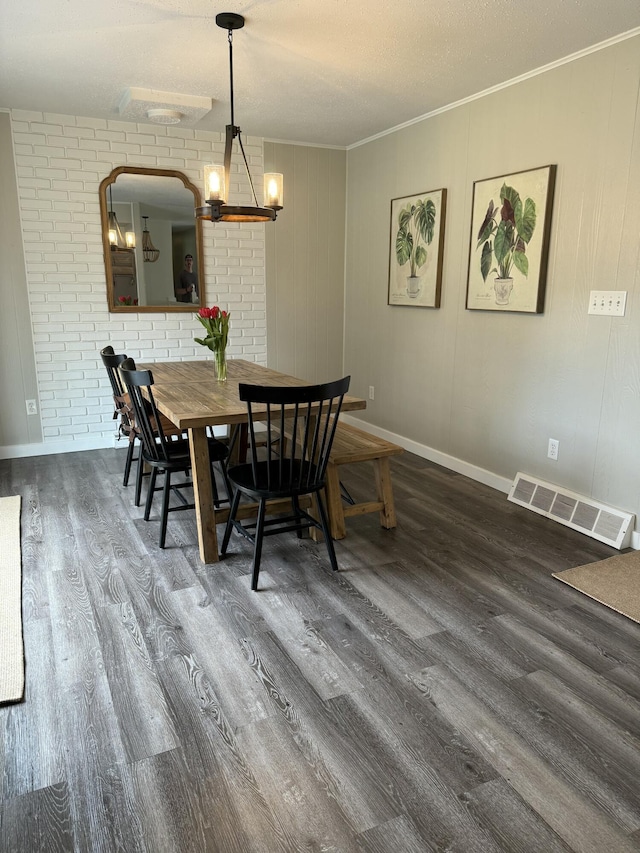 1335 N Sherman Rd, Ludington, MI 49431 - dining space with wood finished floors, a chandelier, crown molding, and baseboards