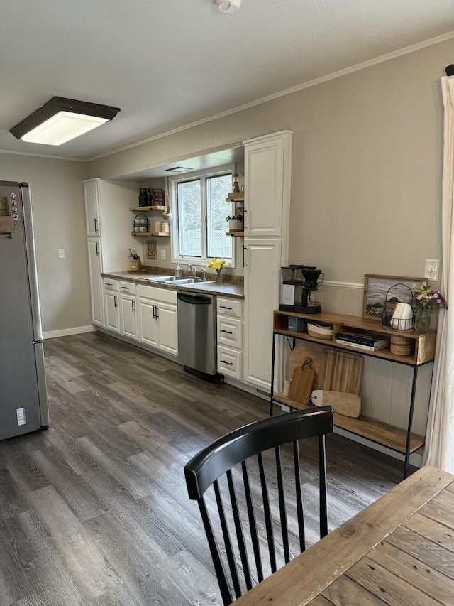 1335 N Sherman Rd, Ludington, MI 49431 - kitchen featuring appliances with stainless steel finishes, dark wood-style flooring, open shelves, white cabinets, and ornamental molding