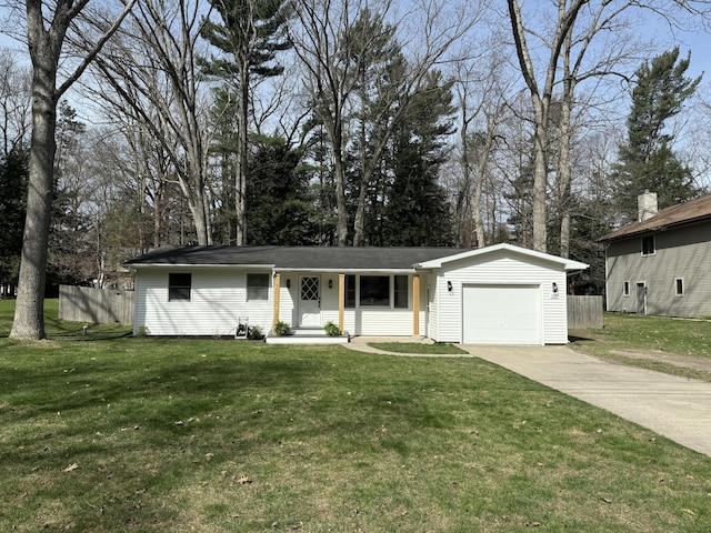1335 N Sherman Rd, Ludington, MI 49431 - ranch-style home featuring a garage, driveway, and view of wooded area
