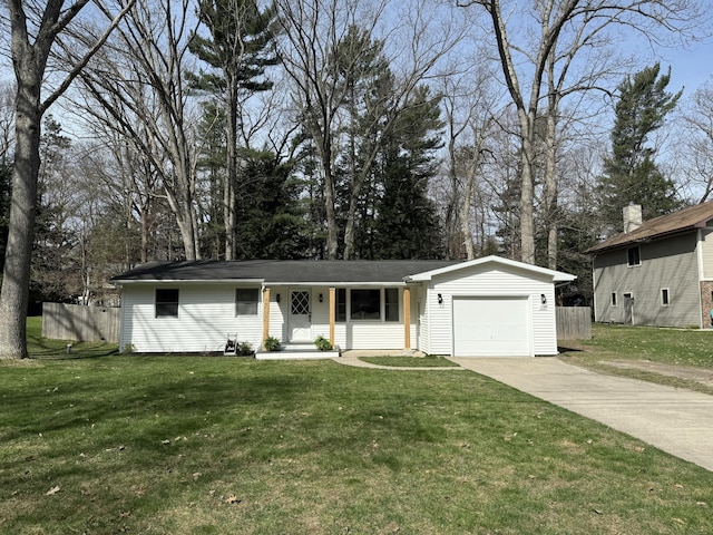 1335 N Sherman Rd, Ludington, MI 49431 - single story home with a garage, concrete driveway, and view of wooded area