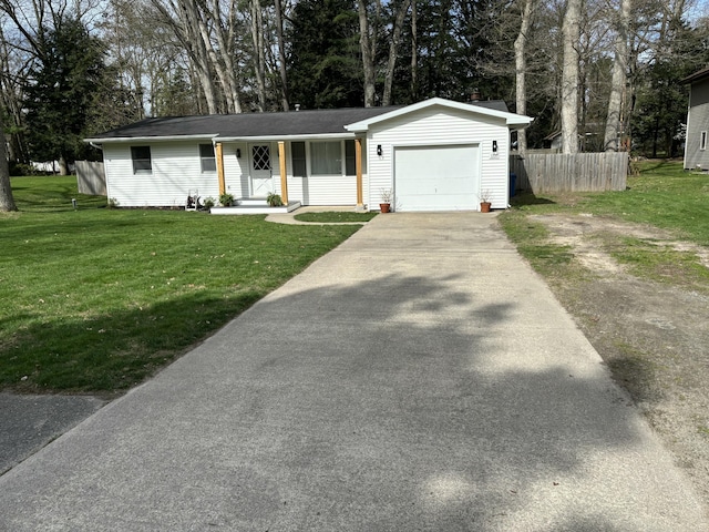 1335 N Sherman Rd, Ludington, MI 49431 - ranch-style house with a garage, driveway, and view of scattered trees
