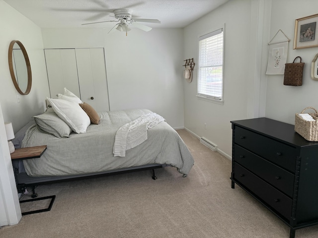 1335 N Sherman Rd, Ludington, MI 49431 - carpeted bedroom with a closet and a ceiling fan