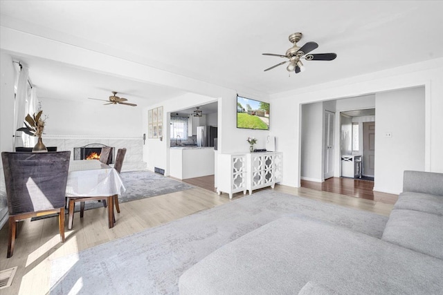 living room with ceiling fan and wood finished floors