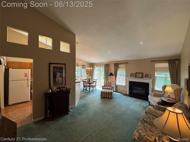 4522 Willow View Ct, Howell, MI 48843 - carpeted living area with vaulted ceiling, a textured ceiling, a fireplace with flush hearth, and baseboards