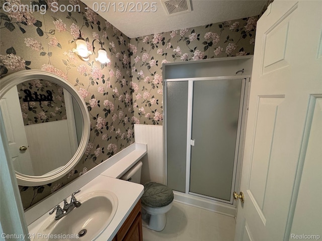 4522 Willow View Ct, Howell, MI 48843 - bathroom featuring wallpapered walls, a stall shower, toilet, vanity, and tile patterned flooring