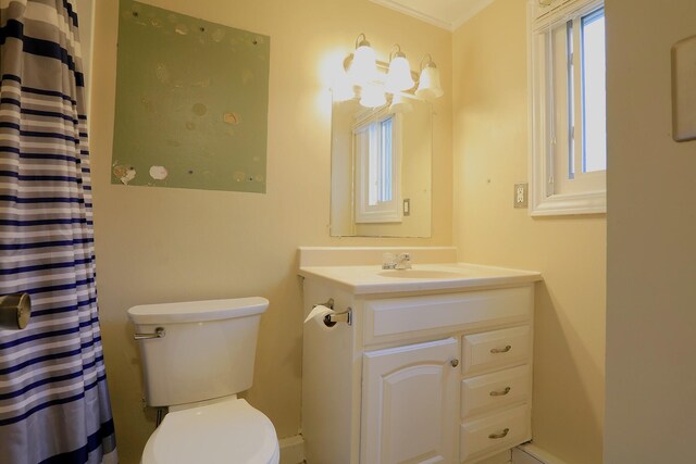 bathroom with toilet, vanity, a shower with curtain, and crown molding