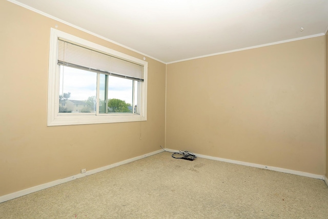 unfurnished room with crown molding, baseboards, and carpet