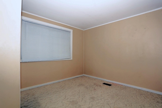 carpeted empty room featuring ornamental molding and baseboards