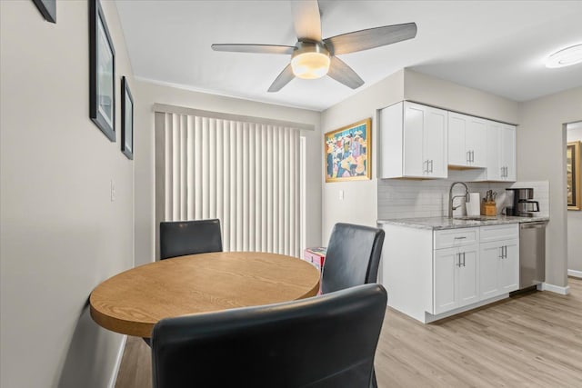 8080 Farnum Ct, Warren, MI 48093 - dining space featuring light wood-style floors, a ceiling fan, and baseboards