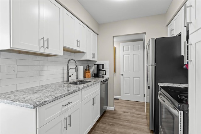 8080 Farnum Ct, Warren, MI 48093 - kitchen featuring appliances with stainless steel finishes, a sink, white cabinets, and wood finished floors
