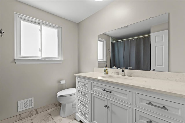 8080 Farnum Ct, Warren, MI 48093 - full bath with marble look tiles, plenty of natural light, toilet, and vanity