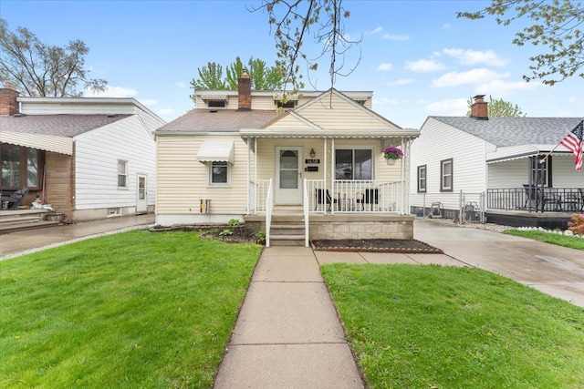 bungalow with a porch and a front yard