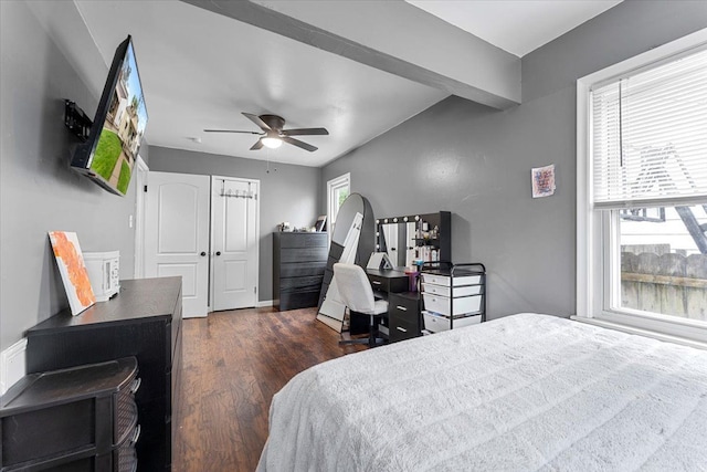 bedroom with multiple windows, dark wood-style floors, a desk, and ceiling fan