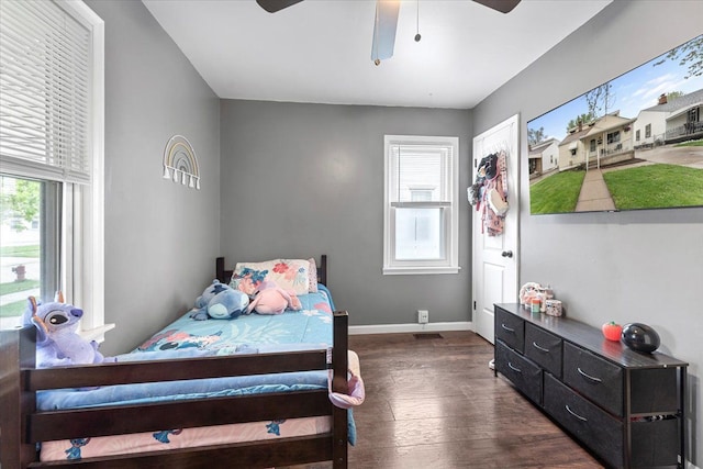 bedroom featuring dark wood finished floors, baseboards, and ceiling fan
