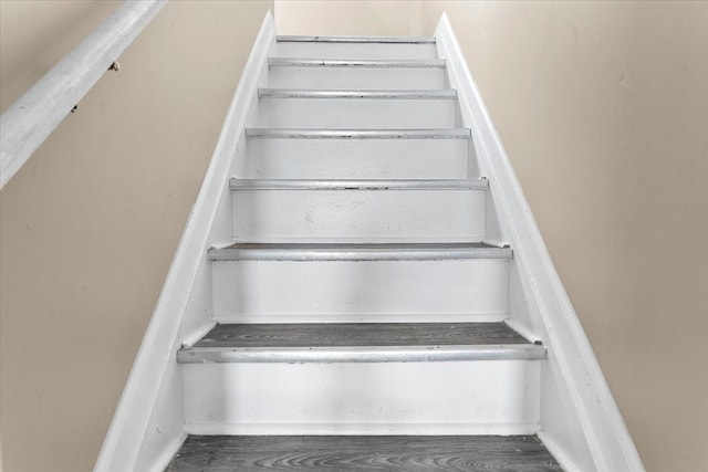stairs featuring wood finished floors