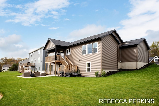 back of property featuring an outdoor hangout area, stairway, a patio, and a lawn