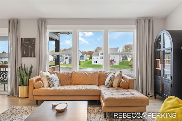 sunroom with plenty of natural light and a residential view
