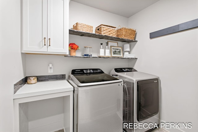 laundry area featuring cabinet space and washing machine and clothes dryer
