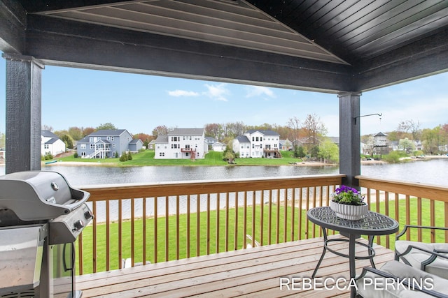 wooden deck with a grill, a water view, and a residential view