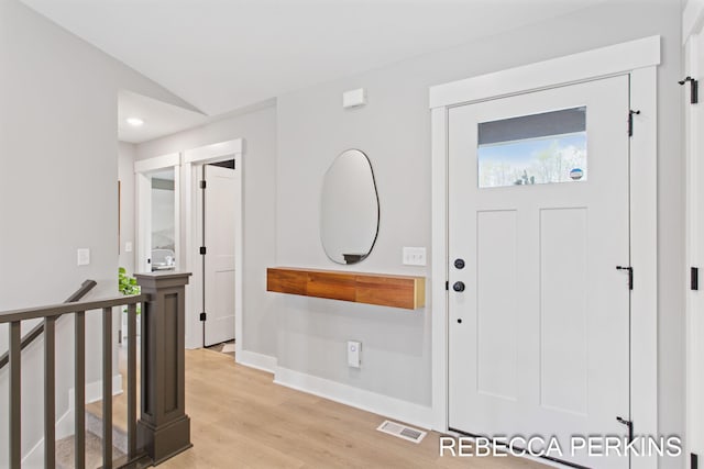 entryway featuring baseboards and light wood-style flooring
