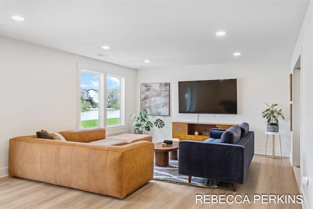 living room with light wood-style floors and recessed lighting