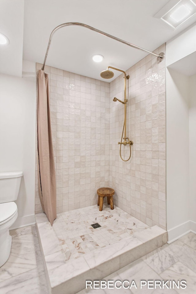 bathroom with a tile shower, toilet, marble look tile flooring, recessed lighting, and baseboards