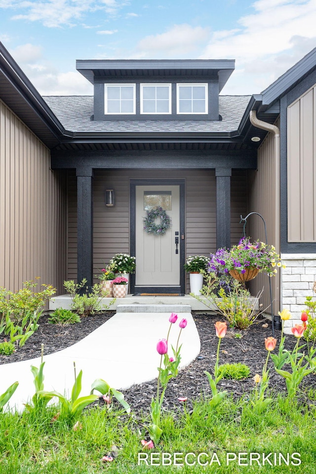 property entrance with a porch and roof with shingles