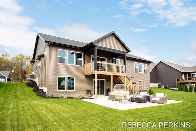 rear view of house with an outdoor living space, a patio area, stairs, and a yard