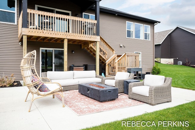 view of patio / terrace featuring stairs, an outdoor living space with a fire pit, and a deck