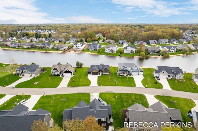 aerial view of residential area featuring a nearby body of water