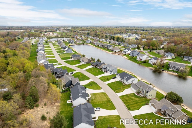 aerial perspective of suburban area with a nearby body of water