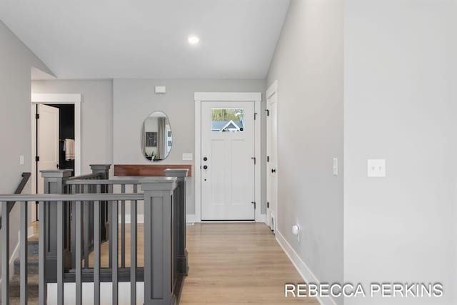 entrance foyer featuring light wood finished floors, baseboards, and recessed lighting