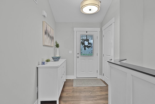 entrance foyer featuring wood finished floors and baseboards