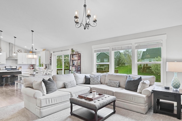 living area with lofted ceiling and a chandelier