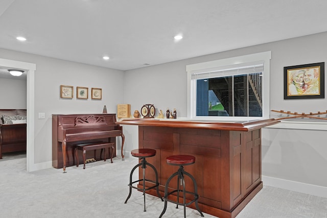 indoor dry bar featuring light carpet, recessed lighting, and baseboards