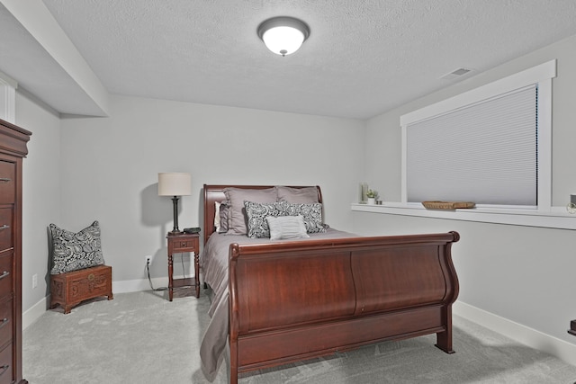 bedroom featuring carpet, a textured ceiling, and baseboards