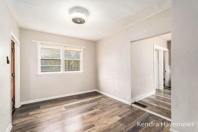 747 Alpine Ave NW, Grand Rapids, MI 49504 - spare room featuring wood finished floors, baseboards, and a textured ceiling