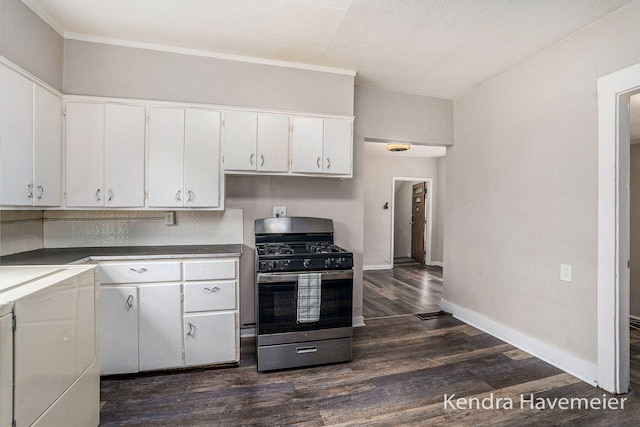 747 Alpine Ave NW, Grand Rapids, MI 49504 - kitchen featuring gas stove, dark wood-style floors, white cabinetry, baseboards, and washer / clothes dryer