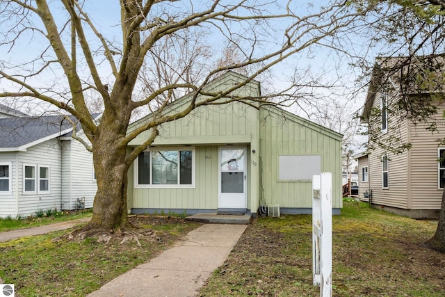 110 W 4th St, Kalkaska, MI 49646 - view of front facade with board and batten siding