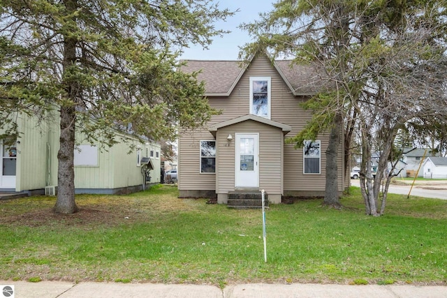 110 W 4th St, Kalkaska, MI 49646 - bungalow with roof with shingles, a front yard, and entry steps