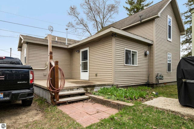 110 W 4th St, Kalkaska, MI 49646 - back of property featuring roof with shingles