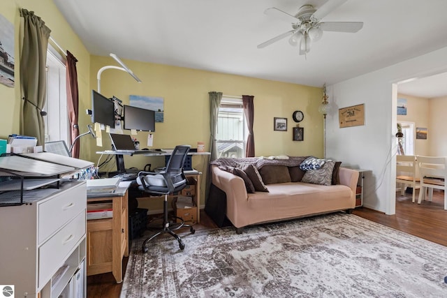 110 W 4th St, Kalkaska, MI 49646 - living area with wood finished floors, ceiling fan, and a desk