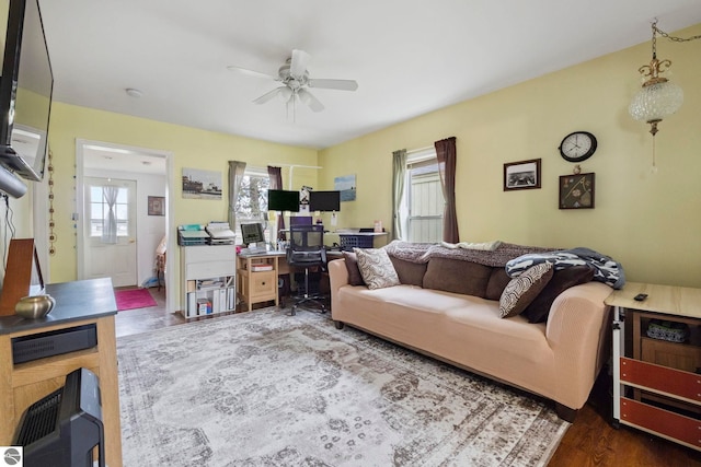 110 W 4th St, Kalkaska, MI 49646 - living area with a desk, a ceiling fan, and wood finished floors