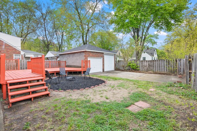 839 E Hayes Ave, Hazel Park, MI 48030 - view of yard with fence, a deck, a detached garage, and an outdoor structure